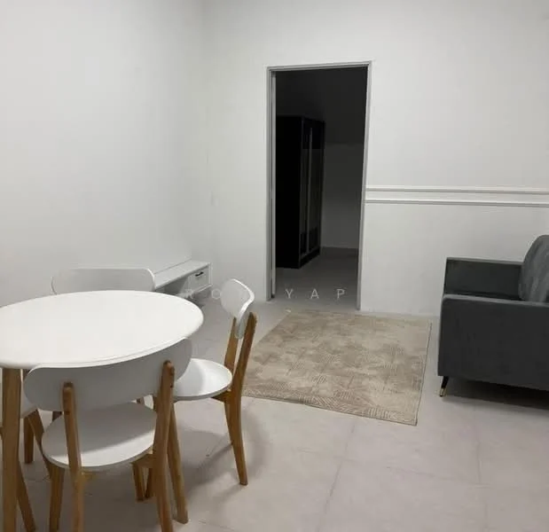 Room features: white painted walls, light grey tiled flooring, round white dining table, 4 wooden dining chairs, grey fabric sofa, area rug with geometric pattern, doorway leading to another room, baseboard trim; style: modern.