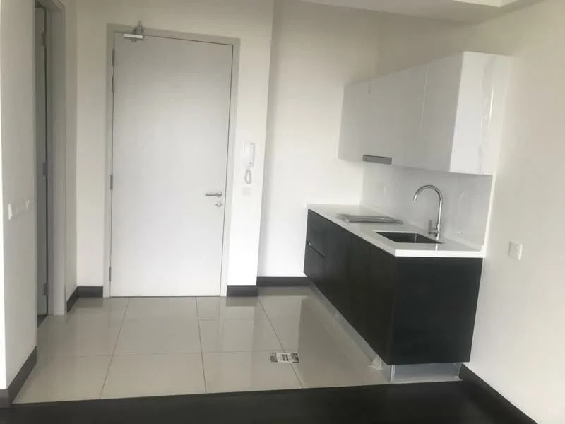 Kitchen features: white glossy cabinetry, black lower cabinetry, white countertop, single-bowl stainless-steel sink, chrome pull-down faucet, ceramic tile flooring, wall-mounted intercom, door to hallway, recessed lighting, neutral painted walls; style: modern.