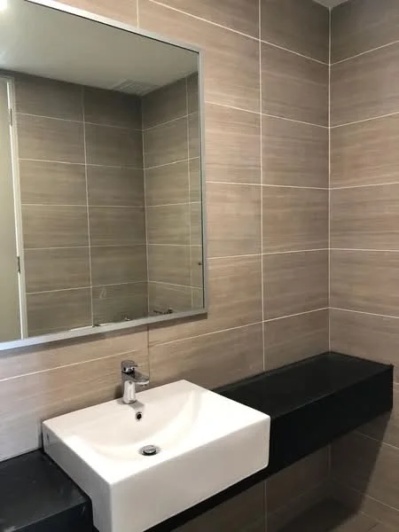 Bathroom features: wall-mounted rectangular sink, chrome basin mixer faucet, black countertop, large wall mirror, beige tiled walls, grey tiled flooring, minimalist design, floating vanity; style: modern.