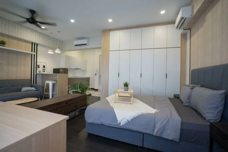 Room features: grey upholstered bed, white bedding, wooden coffee table, grey fabric sofa, white cabinetry with sliding doors, black ceiling fan, recessed LED downlights, pendant lights, air conditioning unit, wooden flooring, greenery in ceramic pot, open shelving, kitchenette area with white cabinets; style: modern.