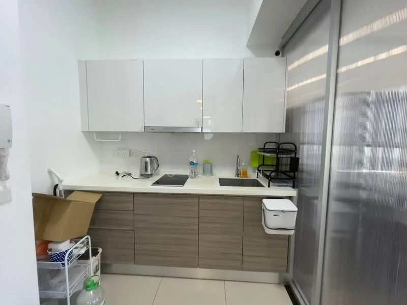 Kitchen features: white glossy upper cabinets, wooden lower cabinets, white countertop, double-bowl stainless-steel sink, chrome pull-down faucet, built-in stove with two burners, microwave, kettle, dish rack, water bottle, plastic storage container, tile backsplash, recessed lighting, floor-to-ceiling glass sliding door; style: modern.