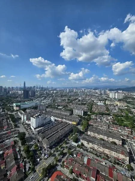 Exterior type: high-rise condominium; features: city skyline view, surrounded by urban landscape, clear blue sky, scattered clouds, multiple residential buildings, green spaces visible, main roads visible; style: modern.
