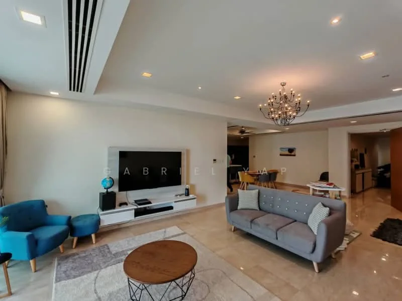 Living features: 3-seater grey fabric sofa, 2 blue accent chairs, round wooden coffee table, wall-mounted TV, TV console with storage, chandelier with multiple bulbs, recessed ceiling lights, marble tile flooring, cream painted walls, decorative wall art, area rug with geometric pattern; style: modern. Room features: open layout, kitchen area visible in background.