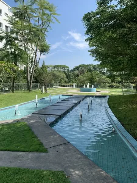 Exterior type: landscape garden; features: water feature with fountains, manicured lawn, pathway with tiles, lush greenery, trees surrounding the area, blue-tiled water channel, fountain in the background, open space; style: modern.