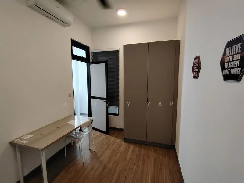 Room features: wooden flooring, white painted walls, 1 wall-mounted split AC, built-in wardrobe in light brown, desk with transparent chair, sliding glass door, window with black frame, decorative wall sign; style: modern.