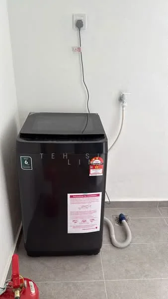 Laundry features: top-load washing machine in black, water inlet hose, drain hose, grey tiled flooring, white painted walls, power outlet, fire extinguisher, label on washing machine.