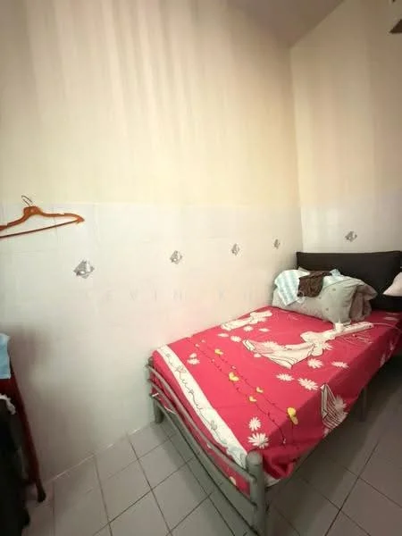 Bedroom features: single bed, pink floral bedspread, white walls, tile flooring, decorative wall tiles, cushions on bed, wooden hanger on wall, small bedside table.