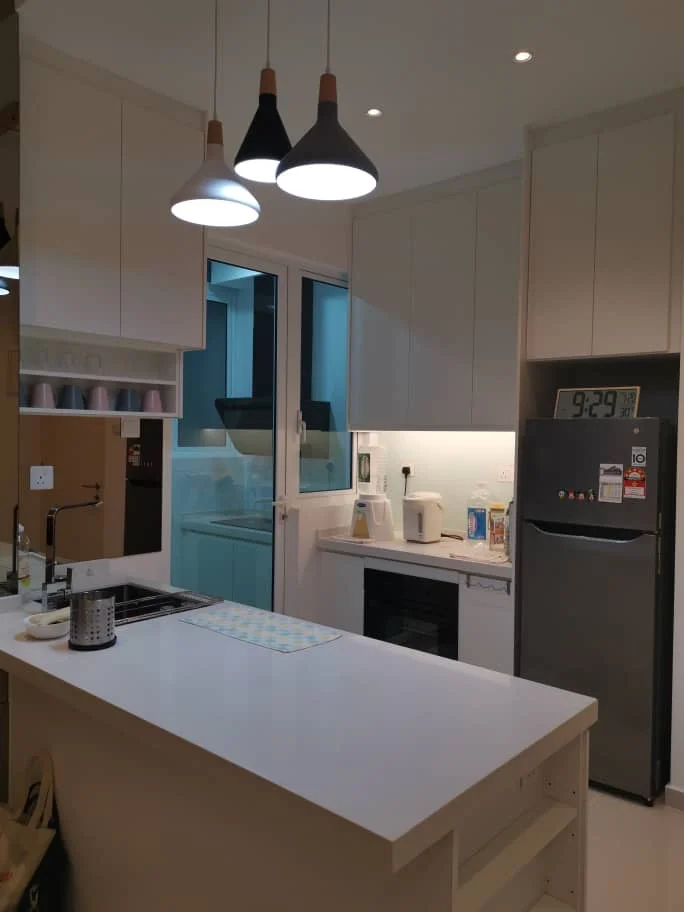 Kitchen features: white cabinetry, white countertop, stainless-steel fridge, built-in oven, ceramic cooktop, kitchen island with seating, pendant lighting with three fixtures, double-bowl stainless-steel sink, window with sheer curtains, recessed downlights, microwave, kettle; style: modern.