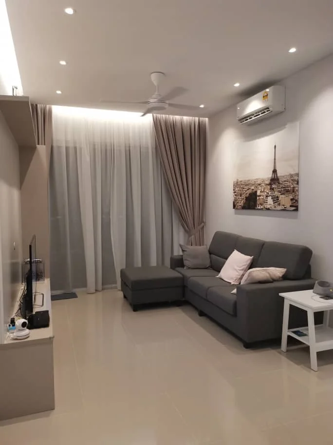 Living features: 3-seater fabric sofa in grey, chaise lounge, light-colored throw pillows, white side table, wall-mounted TV, recessed LED downlights, ceiling fan, floor-to-ceiling sheer curtains, curtains in light brown, decorative wall art with Eiffel Tower, glossy tile flooring, air conditioning unit; style: modern.