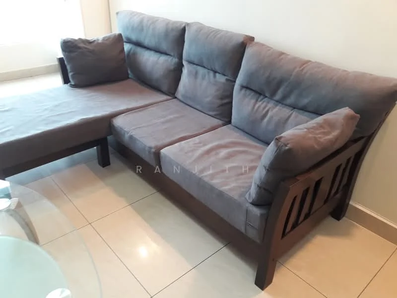 Living features: L-shape sectional sofa in grey fabric, wooden frame, light-colored tiled flooring, neutral painted walls, large window with natural light, glass coffee table; style: modern.
