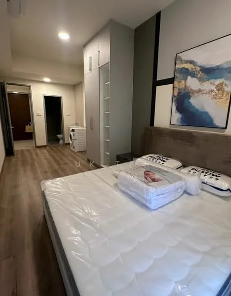 Bedroom features: queen-size bed, upholstered headboard, bedding with decorative pillows, wooden flooring, built-in wardrobe with sliding doors, wall-mounted air conditioning unit, framed artwork on wall, neutral wall color, recessed ceiling lights; style: modern. Bathroom features: one-piece toilet, sink with cabinet, neutral wall color, tile flooring.