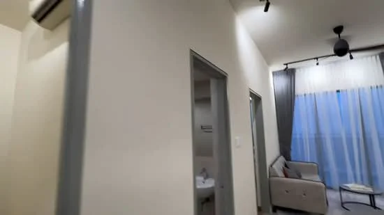 Room features: white painted walls, laminate flooring, recessed downlights, 5-blade ceiling fan, floor-to-ceiling windows with sheer curtains, sofa, curtains, doorway leading to bathroom; style: modern.