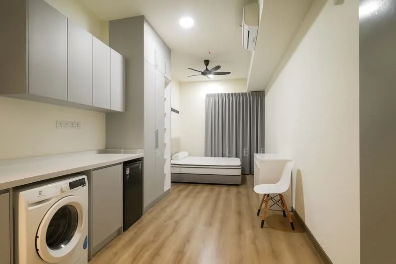 Room features: light wood laminate flooring, white painted walls, ceiling fan with light, wall-mounted split AC, single bed with mattress, built-in wardrobe with grey doors, white desk with wooden legs, grey curtains, washing machine, black mini fridge, recessed ceiling lights; style: modern.