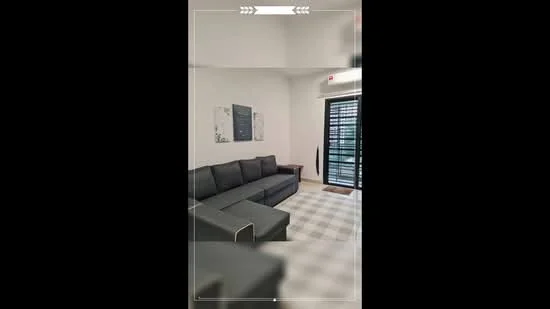Living features: L-shape sectional sofa in grey, coffee table, wall-mounted TV, framed artwork on walls, floor-to-ceiling windows, blackout curtains, light-colored tiled flooring, decorative floor lamp; style: modern.