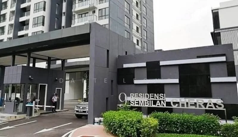 Exterior type: high-rise condominium; features: grey painted facade, glass curtain wall, projecting balconies, manicured lawn, paved driveway, security guard at entrance, intercom panel, perimeter fence, gated entry, double-volume main lobby; style: modern.