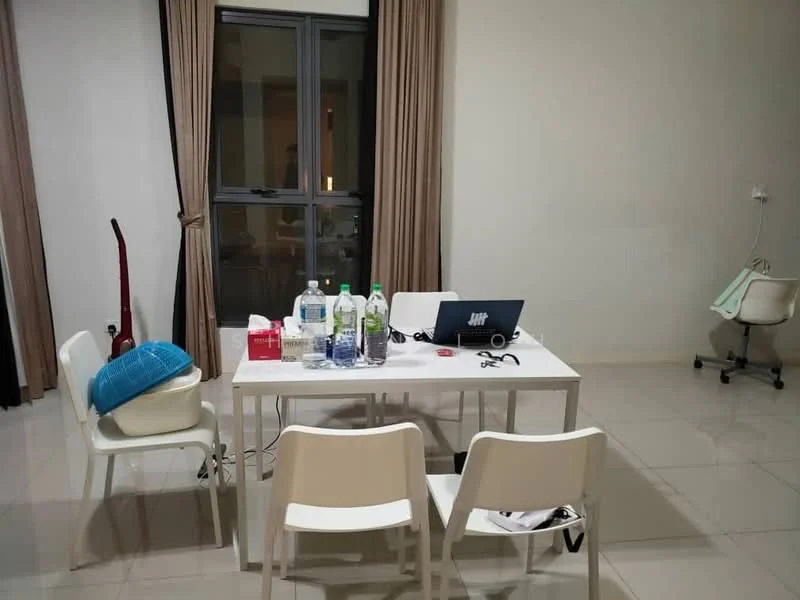 Room features: white painted walls, light grey tiled flooring, large window with dark frame, curtains in beige, white dining table, four white chairs, laptop on table, bottled water on table, vacuum cleaner in corner, plastic chair in corner; style: modern.