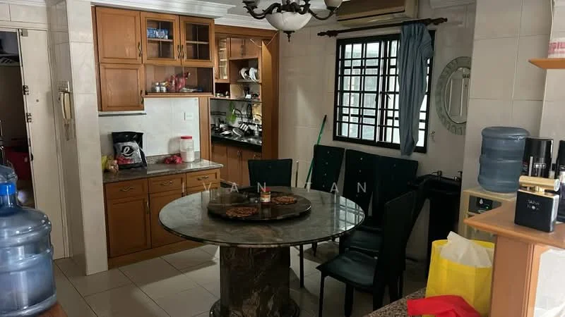 Dining features: round marble dining table, 4 upholstered dining chairs in green, wooden cabinetry with glass-front upper cabinets, white tiled walls, cream tiled flooring, ceiling light fixture with multiple bulbs, wall-mounted mirror, window with black grille, water dispenser, open shelving with various items, kitchen area visible in background; style: traditional.