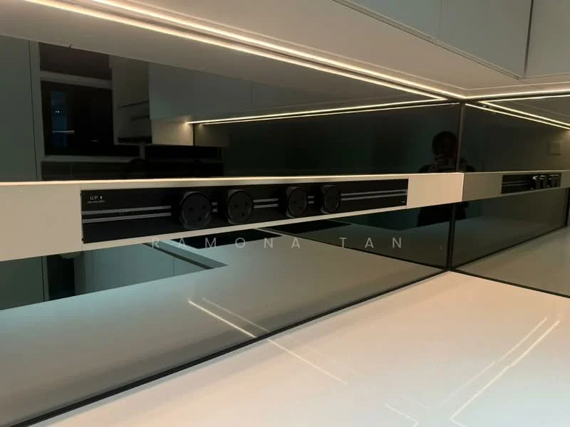 Kitchen features: white countertop, black backsplash, built-in power outlets, under-cabinet lighting, modern cabinetry, stainless-steel appliances, minimalist design, high-gloss finish; style: modern.