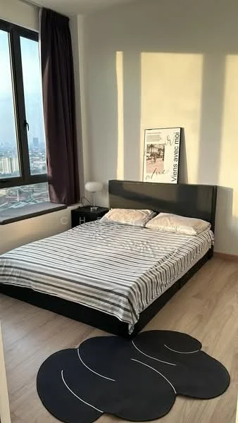 Bedroom features: queen-size bed with striped bedding, black bed frame, floor-to-ceiling window, curtains in dark purple, wooden flooring, decorative wall art, nightstand with lamp, area rug with circular design; style: modern; view: city.