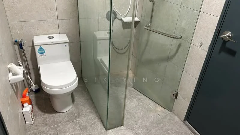 Bathroom features: one-piece toilet, walk-in shower with glass enclosure, chrome shower head, chrome handheld shower, grey tile flooring, grey wall tiles, grab bar, toilet paper holder, shower wall with glass partition; style: modern.