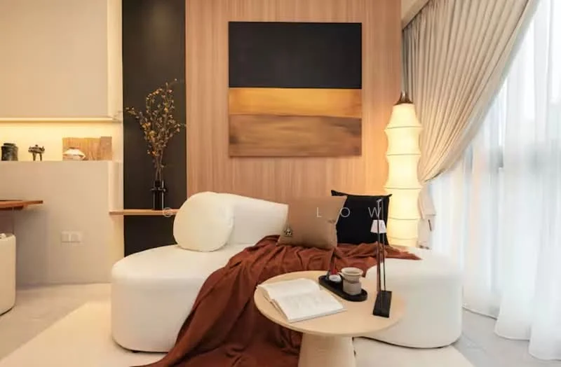 Living features: curved white sofa, brown throw blanket, round wooden coffee table, decorative vase with branches, framed artwork on wall, floor lamp, sheer curtains, wood panel accent wall, recessed lighting, light-colored flooring, decorative book, coffee cup; style: modern.