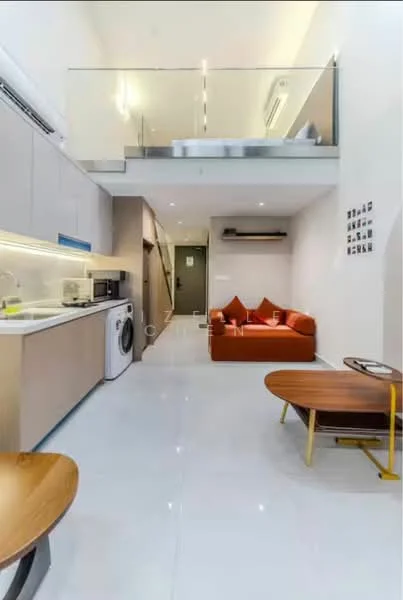 Living features: sofa in orange fabric, coffee table with wooden top and metal legs, floor-to-ceiling windows, recessed LED downlights, white walls, polished tile flooring, air conditioning unit, decorative wall photos; style: modern. Kitchen features: kitchen cabinetry in light wood, stainless-steel sink, built-in microwave, freestanding washing machine, countertop with under-cabinet lighting, ceramic tile backsplash; style: modern.