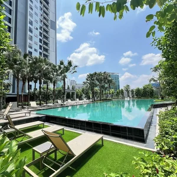 Exterior type: high-rise condominium; features: infinity pool, pool deck with loungers, manicured landscaping, palm trees, tropical landscaping, glass curtain wall on building, surrounded by greenery, sunny weather, modern outdoor furniture; style: modern.