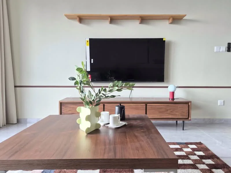 Living features: wooden coffee table, brown sideboard, wall-mounted flat-screen TV, decorative shelf above TV, white ceramic vase with greenery, black ceramic teapot, white cup, red and beige area rug, curtains, grey wall, marble tile flooring; style: modern.
