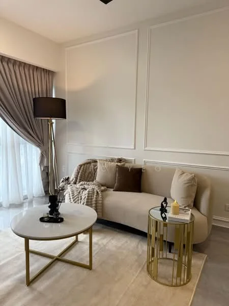 Living features: curved beige fabric sofa, decorative throw pillows, plaid throw blanket, round glass coffee table with gold frame, gold side table, black floor lamp with shade, sheer curtains, white painted walls, light-colored area rug; style: modern.