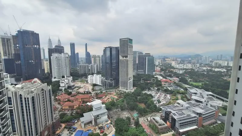 Exterior type: high-rise condominium; features: city skyline view, surrounded by greenery, urban landscape, mixed-use development, visible construction site, high-rise buildings, low-rise buildings, park area, commercial buildings, roadways, open spaces; style: modern.