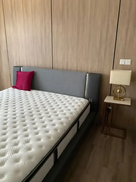 Bedroom features: queen-size bed with upholstered headboard, grey fabric headboard, red decorative pillow, wood panel accent wall, laminate flooring, nightstand with lamp, table lamp with white shade, power outlet on wall; style: modern.