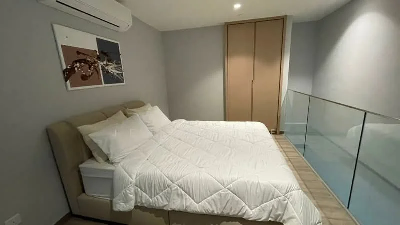 Bedroom features: king-size bed with upholstered headboard, white bedding, wooden flooring, wall-mounted air conditioning unit, framed artwork on wall, built-in wardrobe with sliding doors, glass railing, neutral painted walls, recessed lighting; style: modern.
