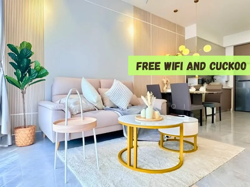 Living features: light grey painted walls, cream sofa with cushions, round coffee table with white top and yellow base, area rug with geometric pattern, indoor plant in decorative pot, dining table with four chairs, pendant lighting, grey tiled flooring; style: modern.