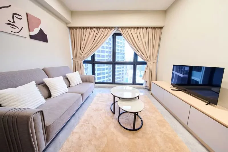 Living features: 3-seater fabric sofa in grey, 2 white decorative cushions, round coffee table with black metal base, area rug in beige, TV console in light wood, wall-mounted TV, floor-to-ceiling windows, curtains in beige, wall art with abstract design, light grey walls, recessed lighting; style: modern; view: city.