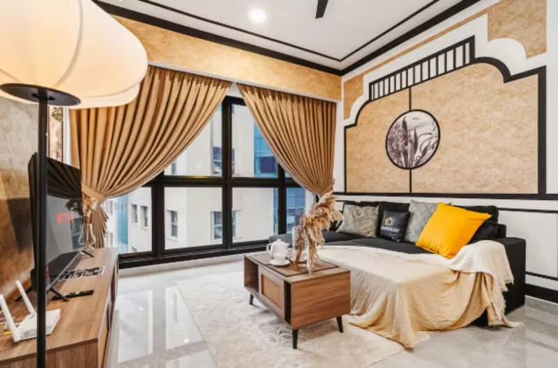 Living features: black sectional sofa, yellow accent pillow, beige throw blanket, wooden coffee table, decorative vase with dried flowers, TV console with TV, floor-to-ceiling windows, curtains in beige, wall with decorative paneling, marble flooring, recessed ceiling lights, wall art with circular frame; style: modern; view: city.