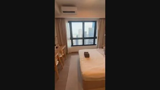 Bedroom features: king-size bed, upholstered headboard, bedside table, wall-mounted TV, floor-to-ceiling windows, curtains, carpet flooring, 1 wall-mounted split AC; style: modern; view: city.