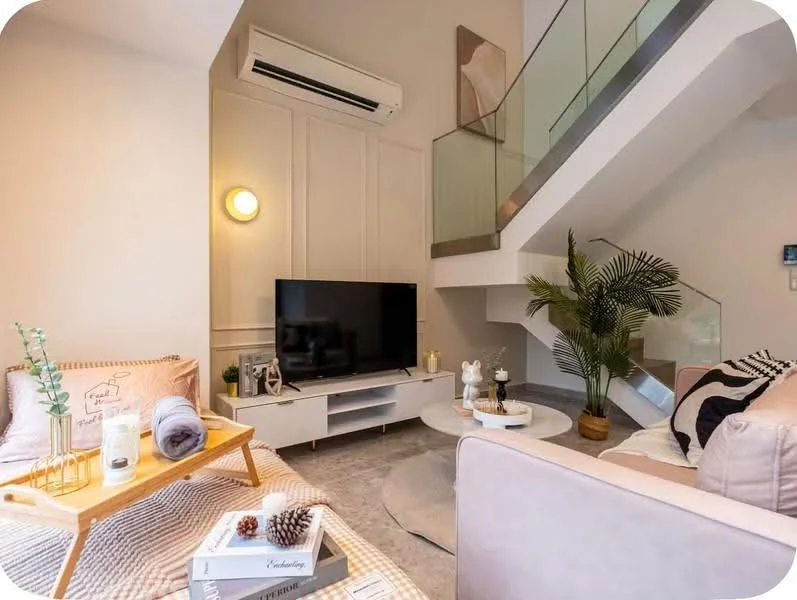 Living features: sofa in light beige, coffee table with round top, TV console with flat-screen TV, wall-mounted air conditioning unit, decorative plant in pot, area rug in light grey, wall paneling, recessed lighting, side table with decorative items, throw pillows in various colors, blanket draped over sofa; style: modern.