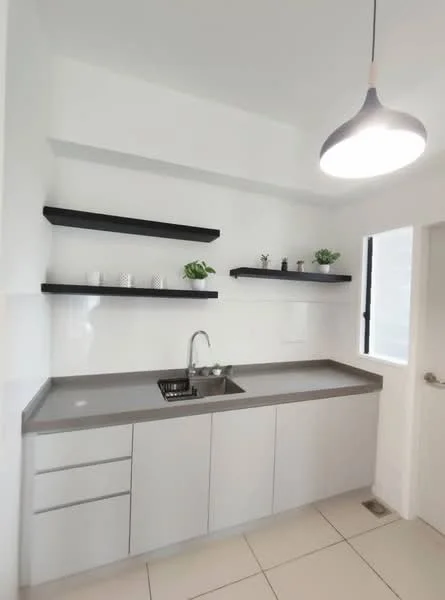 Kitchen features: grey laminate countertop, single-bowl stainless-steel sink, chrome pull-down faucet, white painted walls, floating black shelves, ceramic tile flooring, recessed downlights, window with black frame, minimalist cabinetry with grey finish, decorative potted plants; style: modern.