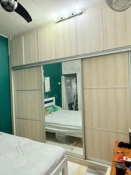 Bedroom features: queen-size bed, upholstered headboard, built-in wardrobe with sliding doors, green accent wall, white painted walls, ceiling fan, wooden flooring, decorative bedside table; style: modern.