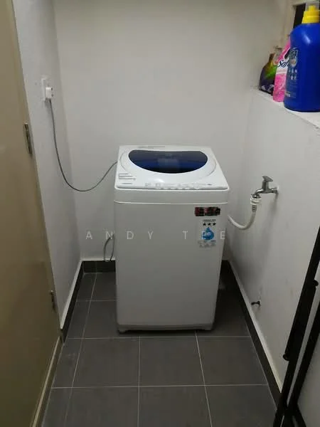 Laundry features: top-load washing machine in white, grey tile flooring, white painted walls, water supply connection, drainage outlet, shelf with cleaning supplies, corner space, plug socket.