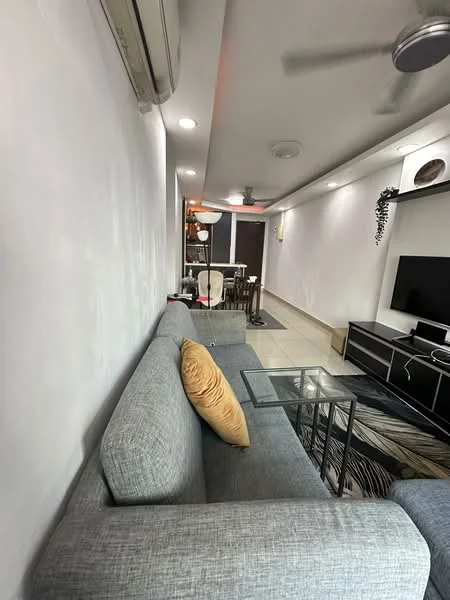 Living features: grey fabric sofa, orange decorative pillow, glass coffee table, wall-mounted TV, black TV console, recessed ceiling lights, ceiling fan, cream painted walls, tile flooring, area rug with geometric pattern, open layout to dining area; style: modern.