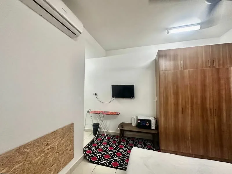 Room features: white painted walls, tile flooring, 1 wall-mounted split AC, wooden wardrobe, wall-mounted TV, small coffee table, ironing board, microwave, area rug with geometric pattern, overhead fluorescent lighting; style: modern.