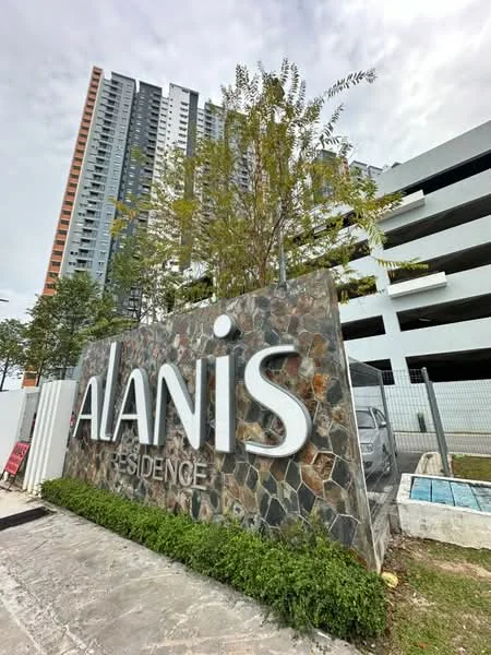 Exterior type: high-rise condominium; features: stone-clad entrance sign, green landscaping with small trees, manicured lawn, multi-storey car park, modern facade with glass and concrete, surrounding greenery, visible parking area; style: modern.