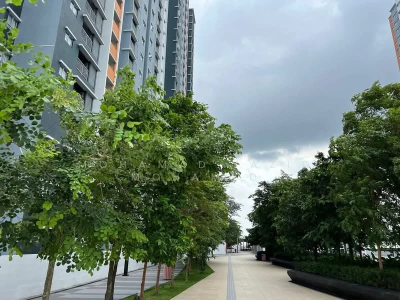 Exterior type: high-rise condominium; features: landscaped walkway, mature trees, paved pathway, greenery along the path, modern building facade, grey painted facade, surrounding greenery; style: modern.