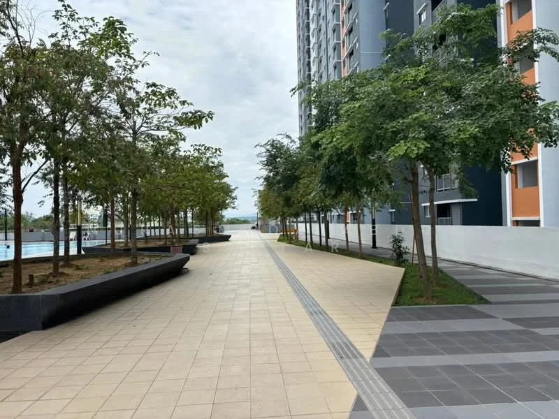 Exterior type: high-rise condominium; features: paved walkway, landscaped area with trees, manicured garden beds, concrete benches, swimming pool visible in background, modern building facade, grey and orange exterior walls, surrounded by greenery; style: modern.