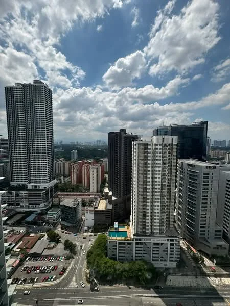 Exterior type: high-rise condominium; features: glass curtain wall, approximately 30-storey high-rise, surrounded by urban landscape, city skyline view, parking lot visible, swimming pool deck, mixed-use development, manicured landscaping; style: modern.