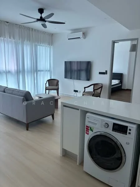 Living features: 3-seater fabric sofa in grey, 2 wooden armchairs, wall-mounted TV, 1 wall-mounted split AC, ceiling fan, light wood flooring, large windows with sheer curtains, decorative wall panel, open layout to kitchen, laundry machine, neutral wall color; style: modern. Kitchen features: laundry machine, white cabinetry, countertop, open layout to living area; style: modern.