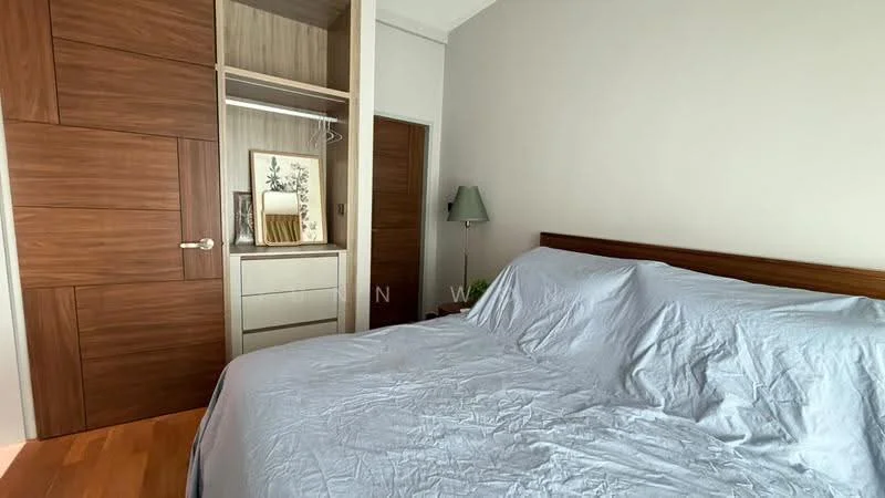 Bedroom features: king-size bed with light blue bedding, wooden headboard, built-in wardrobe with sliding doors, wooden cabinetry, decorative artwork on wall, lampshade on bedside table, wooden flooring, neutral painted walls; style: modern.