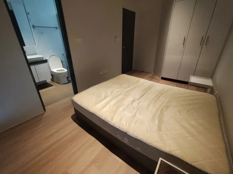Bedroom features: queen-size bed with mattress, wooden flooring, built-in wardrobe with sliding doors, nightstand, neutral wall color, window with natural light, access to bathroom, minimalist decor; style: modern. Bathroom features: toilet, sink, shower area, neutral tiles, mirror, light fixture; style: modern.