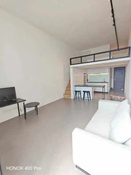 Living features: white painted walls, light grey flooring, sofa in light fabric, coffee table, wall-mounted TV, staircase leading to loft, open layout, recessed lighting, large window, kitchen area visible in background; style: modern.